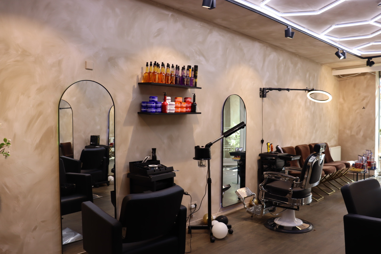 Productplank, kappersstoel en wachtruimte in de salon